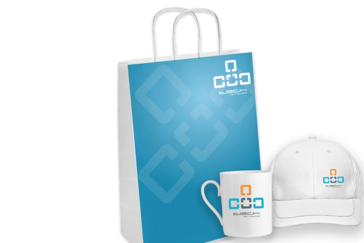 promotional products: blue paper bag, white baseball hat and white coffee mug