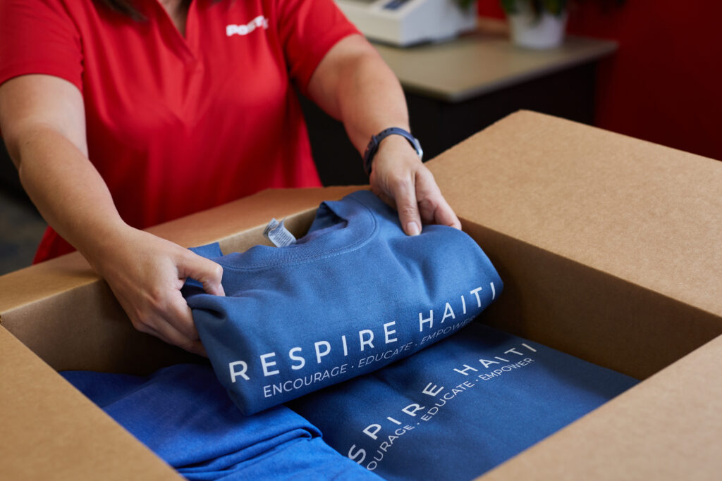 PostNet employee packing tshirts 