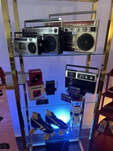 Vintage items on a shelf including vintage radios and rollerblades.